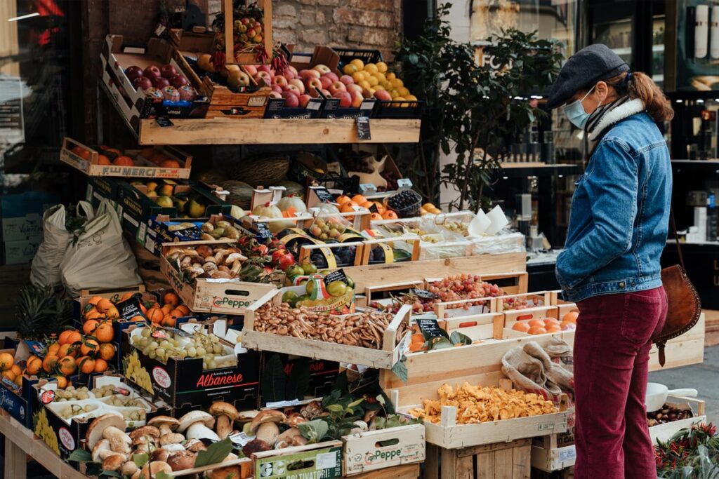 Woman buying fruits and vegetable in a local market
