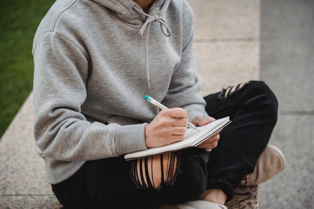 Man writing on his notebook
