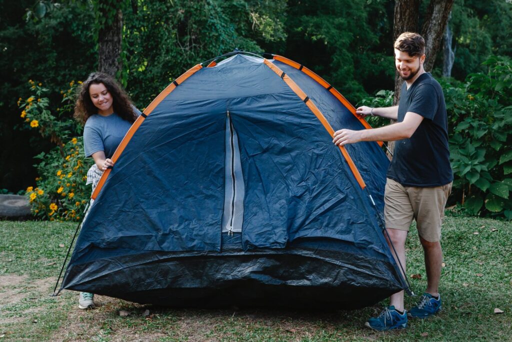 Male and female carrying tent